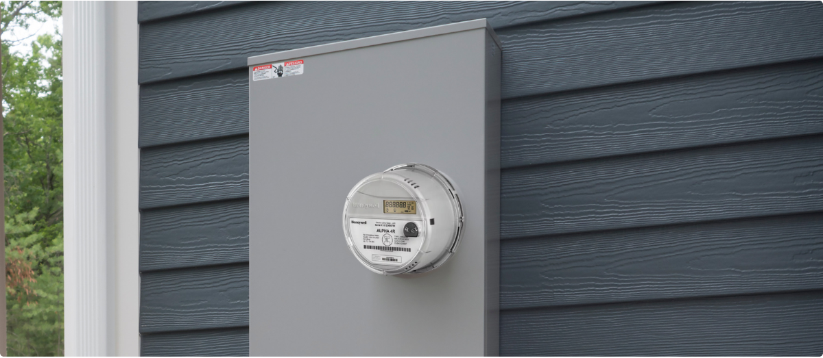 Image of an AMI meter attached to the side of a house