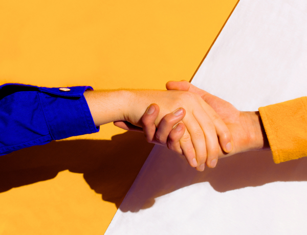 Image of two hands holding to show assistance